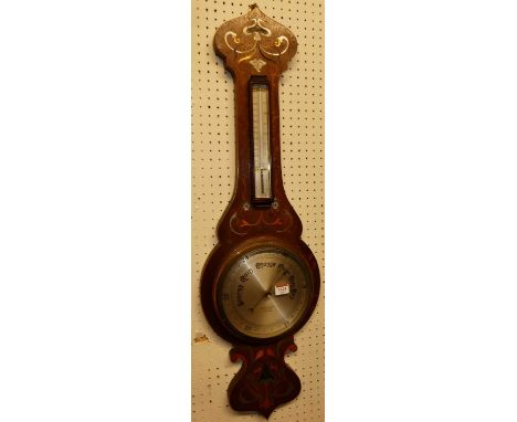 An Art Nouveau oak, satinwood and metal inlaid two-dial aneroid wheel barometer, signed Heath &amp; Stoneman Opticians of Ply