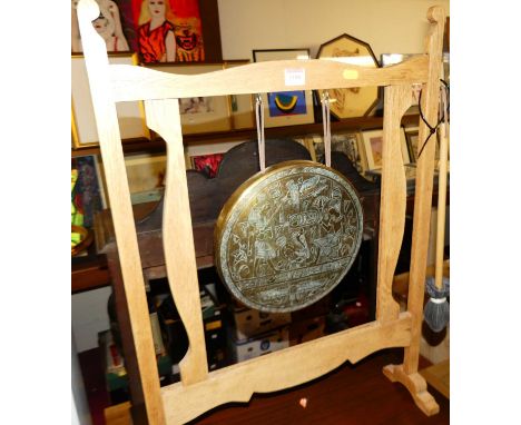 A light oak framed floor standing gong, having engraved brass plaque, with beater, w.54cm