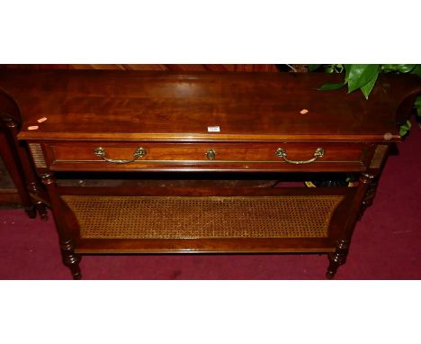 A contemporary cherry wood low single drawer two-tier cane inset console table, w.141cm