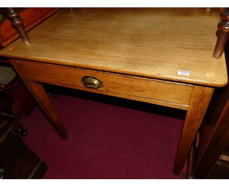 An early 20th century light oak single drawer side table, w.91cm 