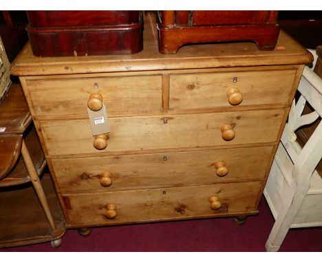 A Victorian pine round cornered chest of two short over three long drawers, on turned supports, with later turned knob handle