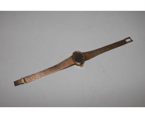 A Tissot 9ct gold cased wrist watch, with 9ct gold strap and clasp. approx. total weight 26gms 