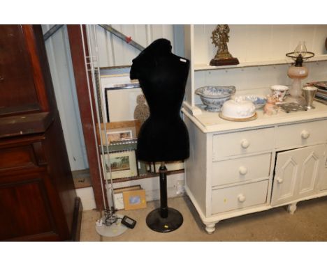 A vintage adjustable mannequin covered in black velvet
