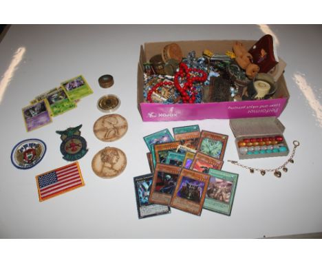 A box containing costume jewellery; small ornaments; trinket boxes; plaque etc.