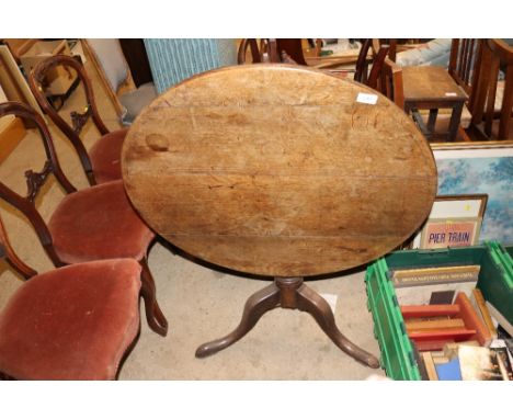 A antique oak snap top tripod occasional table 