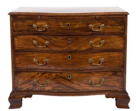 A George III mahogany serpentine fronted chest:, the top with a moulded edge, fitted with a brushing slide and containing fou