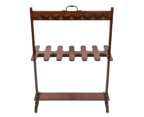 An early 19th Century mahogany riding boot and whip rack:, with central carrying handle, having plain uprights and stretcher 