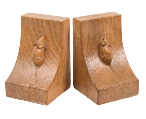 A pair of Robert Thompson (Mouseman) carved oak bookends: of swept square form, each with a mouse climbing up the side, 15cm.