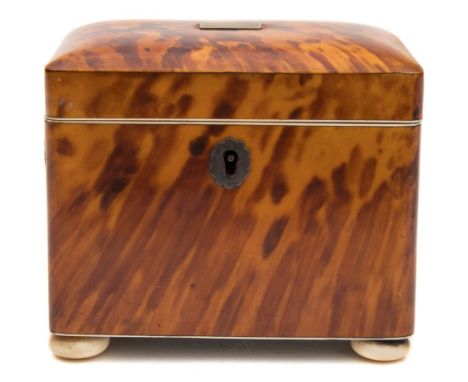 A 19th century blonde tortoiseshell tea caddy: of rectangular outline, with shallow domed hinged lid enclosing a single lidde