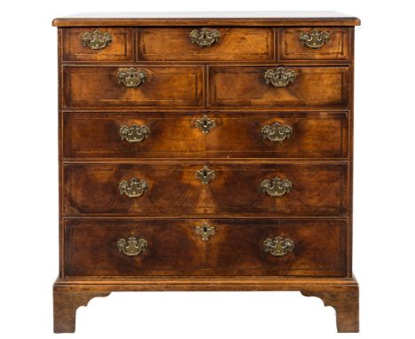 An 18th Century walnut and inlaid rectangular chest:, bordered with boxwood and ebony lines, the top with rounded corners and
