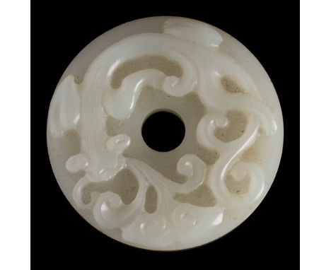 A Chinese 'chilong' jade disc, bi: the stone of pale celadon colour, carved with a sinuous chilong and a lingzhi fungus spray