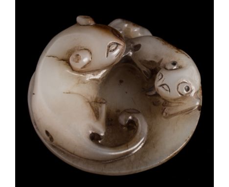 A Chinese jade carving: in the form of a cat and kitten, a moth to the reverse, the stone of pale celadon colour with brown a