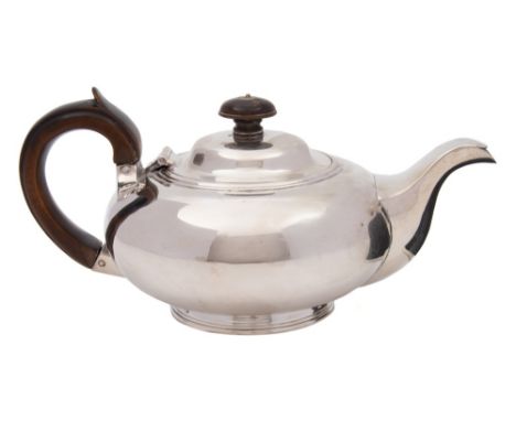 A George IV silver  bachelor's teapot, maker's mark worn WB ?, London, 1822: of squat circular form, on a circular foot, 22cm