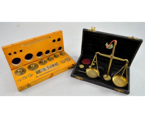 A cased set of postal scales and a cased set of weights.  