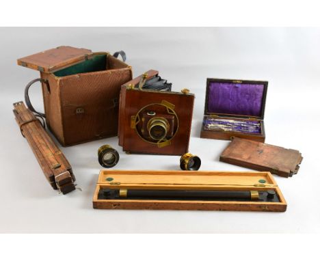 Mahogany and brass folding plate camera with Busch's Rapid Symmetrical lens, a Swift & Son lens No.3593, another, two plates,