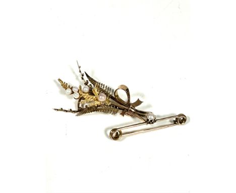 A Edwardian 9ct gold fern and leaf spray brooch set seed pearls, (L x 5.5cm) and a yellow metal bar brooch set single seed pe