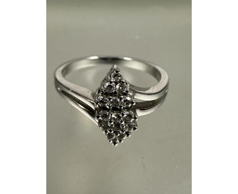 A modern Platinum ring set fifteen diamond points in triangular form, (L x 1cm x W x 0.5), M. 5g