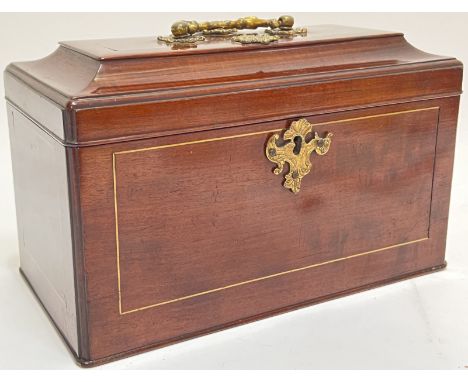 An Edwardian brass strung mahogany tea caddy with Rococo style escutcheon and brass fittings, the lined interior complete wit