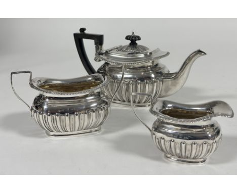 A late 19thc Walker & Hall Birmingham silver three piece morning tea service of rectangular half lobbed design, comprising te