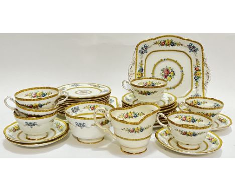 A Paragon China part tea/dessert service decorated with floral sprays comprising six cups, twelve saucers (w- 14cm), a milk j