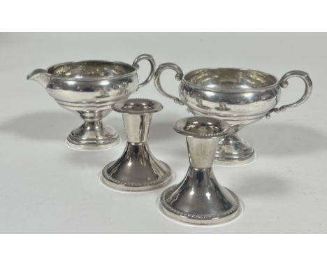 A Crown Sterling silver milk jug and two handled sugar basin of circular form with C scroll handles raised on ring turned wei