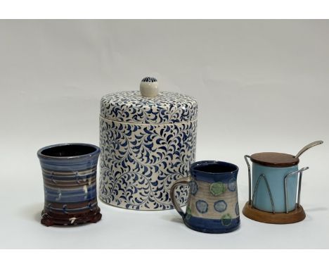 A group comprising a blue and white with all over scrolling leaf design ceramic canister (h-25cm w-19cm), a studio pottery mu
