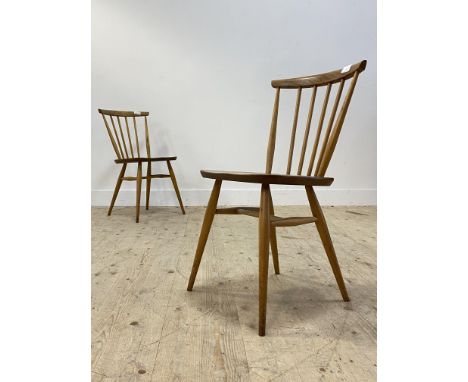 Ercol, a vintage pair of beech and elm comb back chairs, each with saddle seat raised on turned supports H79cm