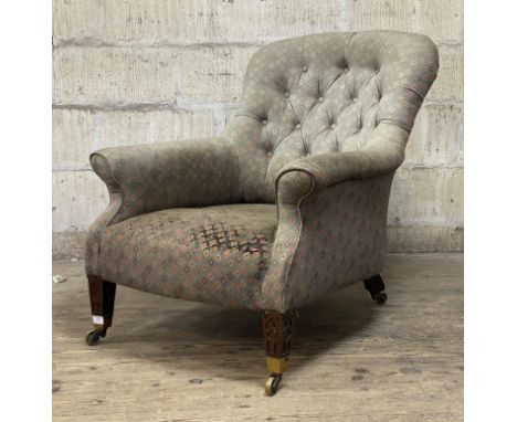 A late 19th century upholstered armchair, the button back and overstuffed seat covered in a pale blue fabric (a/f) with geome