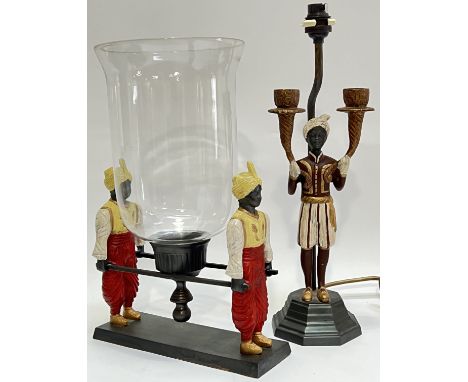 An Orientalist style candle holder with glass shade/guard, modelled with two figures in Arabic dress carrying a litter (h- 36