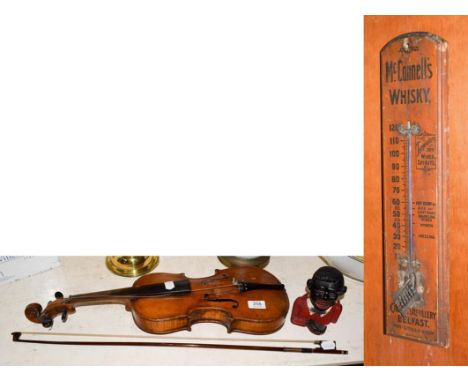 A violin and bow, a McConnell's whisky Cromac distillery Belfast thermometer, and a ''Little Joe'' money bank. Violin 35.75cm