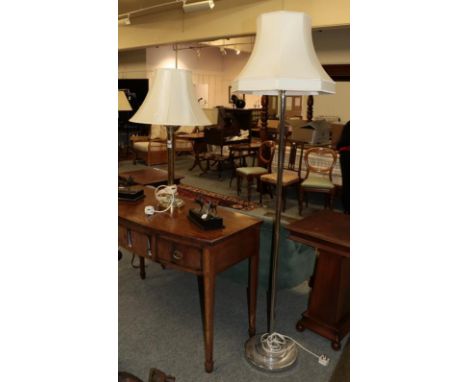 A brass column table lamp with shade and a modern chrome effect standard lamp with shade