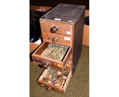 A six drawer wooden cabinet containing a clock makers parts, including clock keys, clock hands, longcase clock spandrels, man