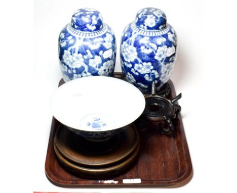A pair of Chinese blue and white ginger jars and covers decorated in underglaze blue with prunus blossom, four character reig