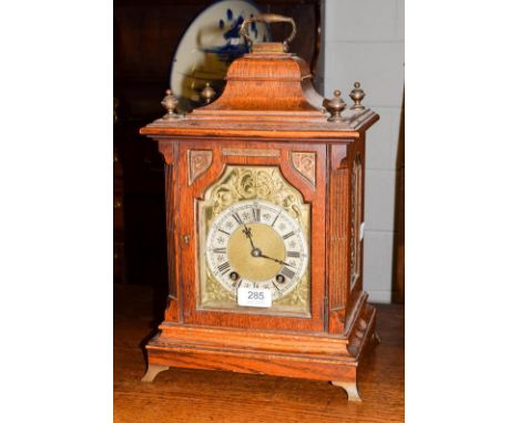 An oak quarter striking mantel clock 