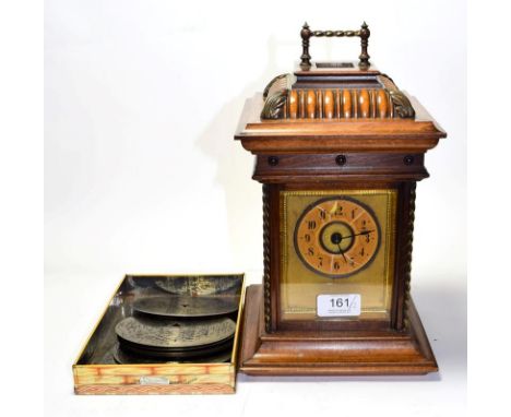 A symphonion mantel clock with nine symphonion discs.  Comb teeth are all complete. The music plays and sounds good. Case wit