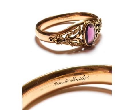 A Victorian gilt metal purple glass hinged bangle, inner measurements 6.3cm by 5.3cm .  Gross weight 31.1 grams. 