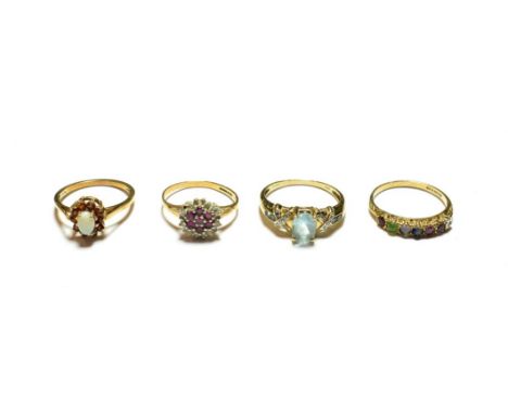 A 9 carat gold opal and garnet cluster ring, finger size P; and three further 9 carat gold gem set rings, various designs and