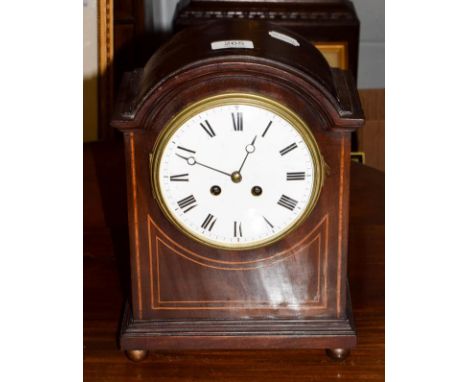 An Edwardian mahogany inlaid striking mantel clock .  Clock comes with a key, movement is going order 