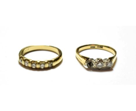 A diamond five stone ring, stamped '9K', finger size L1/2; and a diamond three stone ring, stamped '18CT', finger size L (one