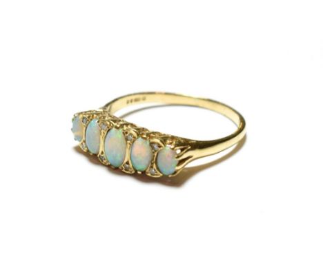 A 9 carat gold opal ring, the five graduated oval opals with eight cut diamond accents, to a plain polished shank, finger siz