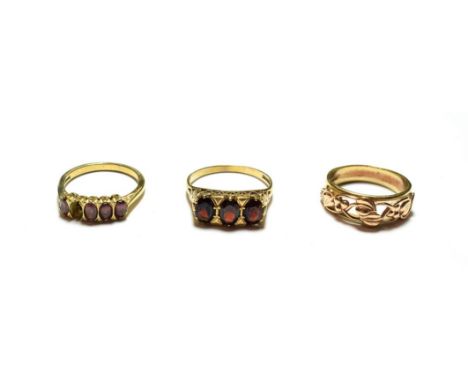 Three 9 carat gold rings including two garnet examples, various designs and finger sizes (one a.f.).  All items would benefit