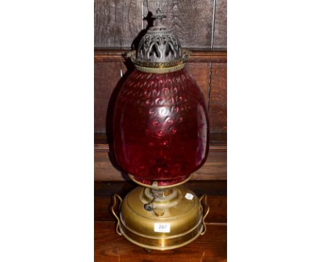 A cranberry glass brass oil lamp 