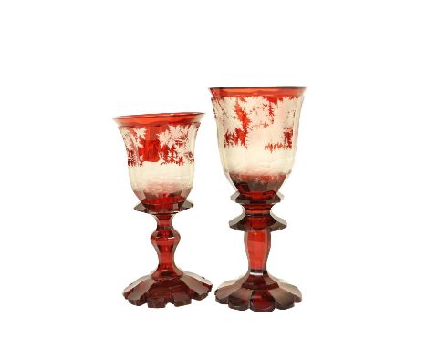 A very large Bohemian ruby glass Goblet, c. 1870, etched with a woodland deer hunt on a stem base, 39cms (15 1/2"), slight re
