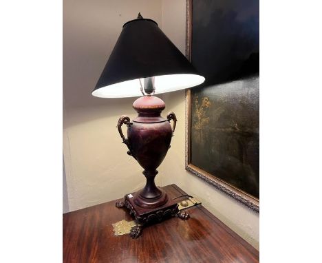 A modern vase shaped bronzed and decorated two handled Table Lamp, on a square base with four paw feet with dark metal shade,