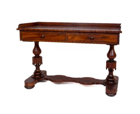 A Victorian mahogany Dressing Table, with three quarter gallery above two frieze drawers on two turned Gothic revival support