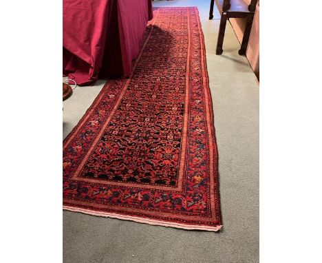 An early 20th Century West Persia Malayer Runner, with all over stylized floral field within a conforming border with narrow 