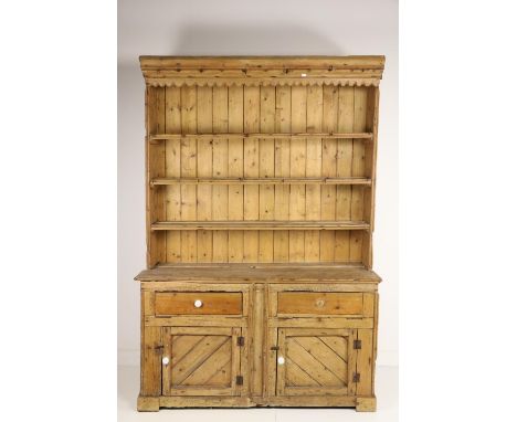 A 19th Century Irish pine Dresser, with four shelf back on a plank top base with two drawers and two sheeted cupboard doors, 