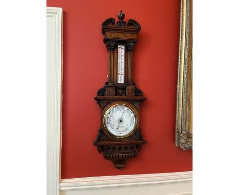 An Edwardian oak cased Aneroid Barometer, by Marratt &amp; Ellis, London Bridge, London with swan neck pediment flanking a re