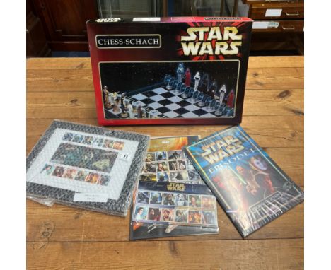 An assortment of Star Wars merchandise including a Star Wars chess set, two sets of Star Wars postage stamps, Star Wars Episo