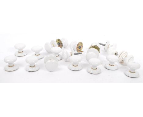 A collection of nineteen white ceramic door handles. All similar sizes and design,two with duel gold circular lines. Diameter